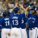 Toronto Blue Jays' Edwin Encarnacion, right, celebrates his three-run home run with teammates Brett Lawrie (13) and Rajai Davis during the fourth inning of a baseball game against the Oakland Athletics in Toronto Thursday, July 26, 2012. (AP Photo/The Canadian Press, Aaron Vincent Elkaim)