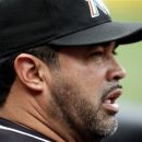 Miami Marlins manager Ozzie Guillen watches the action against the New York Mets during the first inning of their baseball game, Saturday, Sept. 22, 2012, at Citi Field in New York. The Mets beat the Marlins 4-3.(AP Photo/John Dunn)