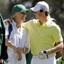 FILE - In this April 10, 2013 file photo, Rory McIlroy, of Northern Ireland, hugs his caddie, tennis player Caroline Wozniacki, during the par three competition before the Masters golf tournament in Augusta, Ga. McIlroy has broken off his engagement to Wozniacki only days after sending out wedding invitations. (AP Photo/Darron Cummings, File)
