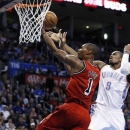 Miami Heat center Chris Bosh (1) shoots in front of Oklahoma City Thunder forward Serge Ibaka (9) in the first quarter of an NBA basketball game in Oklahoma City, Thursday, Feb. 14, 2013. (AP Photo/Sue Ogrocki)