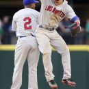 Los Angeles Angels' Mike Trout, right, celebrates with Erick Aybar after defeating the Seattle Mariners 5-3 in a baseball game, Saturday, May 26, 2012, in Seattle. (AP Photo/Elaine Thompson)