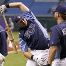 Tampa Bay Rays' Evan Longoria, center, warms up while talking with Jeff Keppinger during batting practice prior to a baseball game against the Toronto Blue Jays, Tuesday, Aug. 7, 2012, in St. Petersburg, Fla. It is Longoria's first game back after being activated from the disabled list. (AP Photo/Mike Carlson)