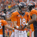 Denver Broncos quarterback Peyton Manning (18) is congratulated by wide receiver Demaryius Thomas (88) after throwing a touchdown pass to Wes Welker against the Philadelphia Eagles in the third quarter of an NFL football game, Sunday, Sept. 29, 2013, in Denver. (AP Photo/Jack Dempsey)