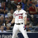 Atlanta Braves' Dan Uggla reacts after striking out to end the fifth inning of a baseball game against the Miami Marlins in Atlanta, Saturday, Aug. 10, 2013. (AP Photo/John Bazemore)