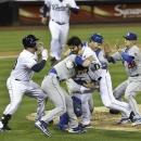 San Diego Padres' Carlos Quentin, center, and teammates battle the Los Angeles Dodgers after Quentin was hit by a pitch thrown by Angeles Dodgers  pitcher Zack Greinke  in the sixth inning of baseball game in San Diego, Thursday, April 11, 2013. (AP Photo/Lenny Ignelzi)
