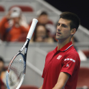 Novak Djokovic of Serbia play with his racket during his semi final match against Andy Murray of Britain at the China Open tennis tournament at the National Tennis Stadium in Beijing, China, Saturday, Oct. 4, 2014. (AP Photo/Vincent Thian)