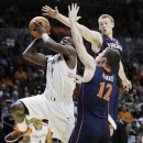 Virginia's Paul Jeperson (2) and Joe Harris (12) pressure Miami's Durant Scott (1) during the second half of an NCAA college basketball game in Coral Gables, Fla., Tuesday, Feb. 19, 2013. Miami won 54-50. (AP Photo/J Pat Carter)