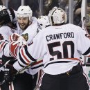Chicago Blackhawks defenseman Brent Seabrook (7) celebrates his game-winning goal against the Boston Bruins with Chicago Blackhawks goalie Corey Crawford (50) during the first overtime period in Game 4 of the NHL hockey Stanley Cup Finals, Wednesday, June 19, 2013, in Boston. Chicago won 6-5. (AP Photo/Elise Amendola)