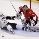 Pittsburgh Penguins' Evgeni Malkin, left, collides into Ottawa Senators goaltender Craig Anderson after being tripped during the first period of Game 4 of their Stanley Cup Eastern Conference semifinal NHL hockey series in Ottawa on Sunday, May 19, 2013. (AP Photo/The Canadian Press, Patrick Doyle)