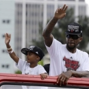 NBA champion Miami Heat's Udonis Haslem, right, acknowledges fans during a parade honoring the team in Miami, Monday, June 24, 2013. (AP Photo/Alan Diaz)