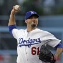 Los Angeles Dodgers starter Josh Beckett pitches to the Washington Nationals in the first inning of a baseball game in Los Angeles Monday, May 13, 2013. (AP Photo/Reed Saxon)