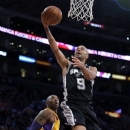 San Antonio Spurs' Tony Parker, of France, goes up for a basket as Los Angeles Lakers' Kobe Bryant, left, watches in the first half of an NBA basketball game in Los Angeles, Tuesday, Nov. 13, 2012. (AP Photo/Jae C. Hong)