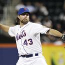New York Mets' R.A. Dickey (43) delivers a pitch during the first inning of a baseball game against the Washington Nationals Tuesday, Sept. 11, 2012, in New York. (AP Photo/Frank Franklin II)