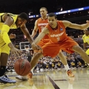 Marquette forward Steve Taylor Jr., (25) and Syracuse guard Michael Carter-Williams (1) reach for a loose ball during the first half of the East Regional final in the NCAA men's college basketball tournament, Saturday, March 30, 2013, in Washington. (AP Photo/Pablo Martinez Monsivais)