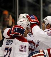 Montreal Canadiens , including left wing Mike Cammalleri (13), congratulate right wing Brian Gionta (21) after Gionta scored a goal in the third period of an NHL hockey game against the New York Islanders at Nassau Coliseum in Uniondale, N.Y., Thursday, Nov. 17, 2011.
