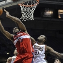 Washington Wizards' Trevor Booker (35) scores over Washington Wizards' Steven Gray (21) during the first half of an NBA basketball game, Saturday, Oct. 20, 2012, in Milwaukee. (AP Photo/Jim Prisching)