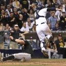 Pittsburgh Pirates' Francisco Cervelli scores on the high throw to San Diego Padres catcher Derek Norris during the sixth inning of a baseball game Thursday, May 28, 2015, in San Diego. (AP Photo/Don Boomer)
