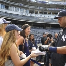 New York Yankees' Derek Jeter signs autographs during batting practice before the Yankees' baseball against the Tampa Bay Rays at Yankee Stadium on Friday, July 26, 2013 in New York. (AP Photo/Kathy Kmonicek)