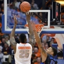 Syracuse's Rakeem Christmas scores against DePaul's Derrell Robertson during the first half of an NCAA college basketball game in Syracuse, N.Y., Wednesday, March 6, 2013. (AP Photo/Kevin Rivoli)