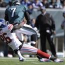 New York Giants strong safety Antrel Rolle (26) sacks Philadelphia Eagles quarterback Michael Vick (7) during the first half of an NFL football game on Sunday, Oct. 27, 2013, in Philadelphia. (AP Photo/Michael Perez)