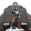 A statue of Branch Rickey is covered in snow outside of Coors Field before a baseball game between the New York Mets and the Colorado Rockies, Monday, April 15, 2013, in Denver. The game has been postponed by a heavy spring snowstorm. The teams will play a split-doubleheader Tuesday. (AP Photo/Jack Dempsey)