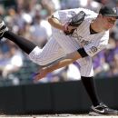 Colorado Rockies starting pitcher Jeff Francis, challenges San Diego Padres' Logan Forsythe, during the first inning of a baseball game Sunday, Sept. 2, 2012 in Denver. (AP Photo/Barry Gutierrez)