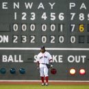 Boston Red Sox's Darnell McDonald stands in front of the scoreboard in the eighth inning of a baseball game against the New York Yankees in Boston, Saturday, April 21, 2012. (AP Photo/Michael Dwyer)