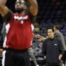 Miami Heat's Erik Spoelstra, right, watches Dwyane Wade shoot during NBA basketball practice, Saturday, June 15, 2013, in San Antonio. The Heat take on the San Antonio Spurs in Game 5 of the NBA Finals on Sunday, with the best-of-seven games series even at 2-2. (AP Photo/David J. Phillip)