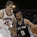 San Antonio Spurs' Tony Parker (9) drives past Cleveland Cavaliers' Tyler Zeller (40) during the first quarter of an NBA basketball game Wednesday, Feb. 13, 2013, in Cleveland. (AP Photo/Tony Dejak)