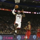 LeBron James of the Miami Heat goes up for a hoop during an NBA preseason basketball game against the Los Angeles Clippers in Shanghai, China, Sunday Oct. 14, 2012. (AP Photo/Kin Cheung)