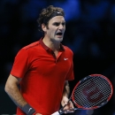 Switzerland's Roger Federer shouts out during his singles ATP World Tour Finals semifinal tennis match against Switzerland's Stan Wawrinka at the O2 Arena in London, Saturday, Nov. 15, 2014. (AP Photo/Kirsty Wigglesworth)