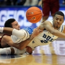 Duke's Quinn Cook (2) collides with Santa Clara's Evan Roquemore, left, while chasing a loose ball during the first half of an NCAA college basketball game in Durham, N.C., Saturday, Dec. 29, 2012. (AP Photo/Ted Richardson)