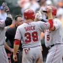 Los Angeles Angels designated hitter Albert Pujols (5) celebrates his two-run home run against the Baltimore Orioles with teammates Josh Hamilton (32) and J.B. Shuck (39) during the seventh inning of a baseball game, Wednesday, June 12, 2013, in Baltimore. (AP Photo/Nick Wass)