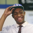 FILE - In this Dec. 20, 2012, file photo, Simeon Career Academy's Jabari Parker smiles as he puts on a Duke University cap after announcing he will be attending Duke during a news conference at his high school in Chicago. Parker has signed his letter of intent to play at Duke, the school announced Thursday, May 2, 2013. Because that decision came in December after the conclusion of the fall signing period, Parker had to wait until the spring signing period began April 17 to make it official. (AP Photo/Charles Rex Arbogast, File)