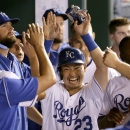 Kansas City Royals' Norichika Aoki, from Japan, celebrates in the dugout after scoring on a single by Alcides Escobar during the seventh inning of a baseball game against the Oakland Athletics, Monday, Aug. 11, 2014, in Kansas City, Mo. (AP Photo/Charlie Riedel)