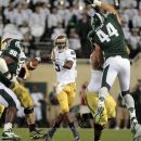 Notre Dame quarterback Everett Golson, center, looks to pass between Michigan State's Marcus Rush (44) and Anthony Rashad White (98) during the first quarter of an NCAA college football game, Saturday, Sept. 15, 2012, in East Lansing, Mich. (AP Photo/Al Goldis)