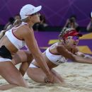 United States' Jennifer Kessy, left, looks on as April Ross, right, reaches for  a ball   during the women's gold medal beach volleyball match against the other US team at the 2012 Summer Olympics, Wednesday, Aug. 8, 2012, in London. (AP Photo/Petr David Josek)