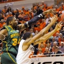 Baylor forward Cory Jefferson, left, reaches over Oklahoma State forward Michael Cobbins for a rebound during the first half of an NCAA college basketball game in Stillwater, Okla., Wednesday, Feb. 6, 2013. (AP Photo/Brody Schmidt)