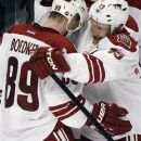 Phoenix Coyotes' Ray Whitney (13) celebrates with Mikkel Boedker (89) after the Coyotes defeated the Chicago Blackhawks 3-2 in Game 3 of an NHL hockey Stanley Cup first-round playoff series in Chicago, Tuesday, April 17, 2012. (AP Photo/Nam Y. Huh)