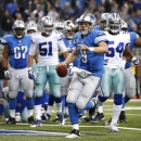 Detroit Lions quarterback Matthew Stafford (9) celebrates scoring on a 1-yard touchdown run against the Dallas Cowboys in the fourth quarter of an NFL football game in Detroit, Sunday, Oct. 27, 2013. (AP Photo/Rick Osentoski)