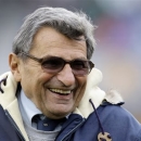 FILE - In this Oct. 17, 2009 file photo, Penn State coach Joe Paterno smiles as he walks the field before an NCAA college football game against Minnesota in State College, Pa. The family of the late coach will be joined by former players and others connected to Penn State in a lawsuit that seeks to overturn the NCAA's strict sanctions against the football program for the Jerry Sandusky child sex abuse scandal. Paterno family lawyer Wick Sollers says the 40-page suit will be filed Thursday, May 30, 2013, in state court in Centre County, home of Penn State's main campus. (AP Photo/Carolyn Kaster, File)