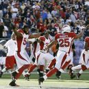 Arizona Cardinals linebacker Quentin Groves (54) and safety Kerry Rhodes (25) join teammates in celebrating their 20-18 win against the New England Patriots in an NFL football game, Sunday, Sept. 16, 2012, in Foxborough, Mass. (AP Photo/Elise Amendola)