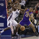 Los Angeles Lakers' Metta World Peace (15) and Charlotte Bobcats' Michael Kidd-Gilchrist (14) battle for a loose ball during the first half of an NBA basketball game in Charlotte, N.C., Friday, Feb. 8, 2013. (AP Photo/Chuck Burton)