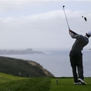 Tiger Woods hits his tee shot on the par three third hole on the South Course at Torrey Pines during the third round of the Farmers Insurance Open PGA golf tournament Sunday, Jan. 27, 2013, in San Diego. (AP Photo/Lenny Ignelzi)