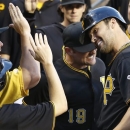 Pittsburgh Pirates' Garrett Jones, right, head-butts with teammate Michael McKenry (19) as he celebrates with teammates in the dugout after hitting a home run in the fourth inning of a baseball game against the Milwaukee Brewers on Saturday, June 29, 2013, in Pittsburgh. (AP Photo/Keith Srakocic)
