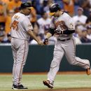 Baltimore Orioles' Chris Davis, right, bumps fists with third base coach DeMarlo Hale after Davis hit a fourth-inning home run off Tampa Bay Rays starting pitcher James Shields during a baseball game, Tuesday, Oct. 2, 2012, in St. Petersburg, Fla. (AP Photo/Chris O'Meara)