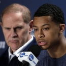 Michigan head coach John Beilein watches as Trey Burke speaks during a news conference for their NCAA Final Four tournament college basketball game Sunday, April 7, 2013, in Atlanta. Michigan plays Louisville in the championship game on Monday. (AP Photo/Chris O'Meara)