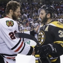 Chicago Blackhawks center Michal Handzus (26), of Slovakia, shakes hands with Boston Bruins center Patrice Bergeron (37) after the Blackhawks beat the Bruins 3-2 in Game 6 of the NHL hockey Stanley Cup Finals Monday, June 24, 2013, in Boston. (AP Photo/Elise Amendola)