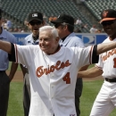 FILE - In this Saturday, June 26, 2010 file photo, former Baltimore Orioles manager Earl Weaver (4) waves to the crowd after taking the lineup card out before the start of a baseball game between the Orioles and Washington Nationals, in Baltimore, as members of the Orioles' 1970 team were honored before the start of the game. At right is interim manager Juan Samuel (11). Weaver, the fiery Hall of Fame manager who won 1,480 games with the Baltimore Orioles, has died, the team announced Saturday, Jan. 19, 2013. He was 82. (AP Photo/Rob Carr, File)