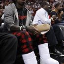 FILE - In this Jan. 27, 2012 file photo, Rapper Lil Wayne sits courtside during an NBA basketball game between the Miami Heat and New York Knicks, in Miami. The Thunder say Lil Wayne is welcome to attend a playoff game in Oklahoma City, but needs to buy a ticket just like everyone else. The rapper created a stir Thursday, May 31, 2012 by posting on Twitter that he was 